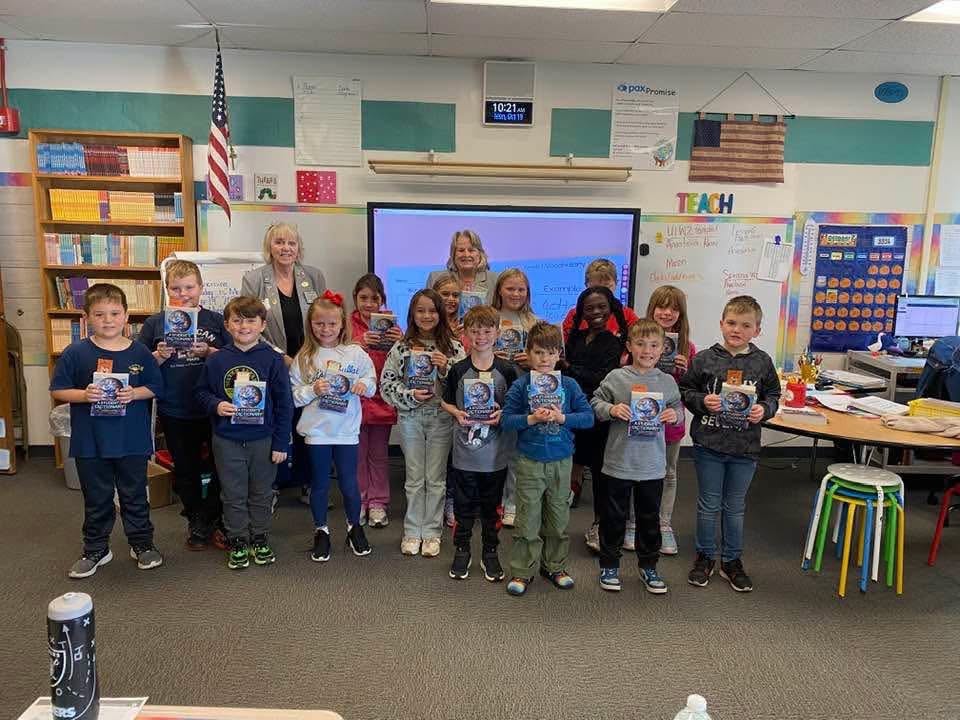 Third graders at Sackets Harbor receiving dictionaries from Watertown Elks Lodge #496